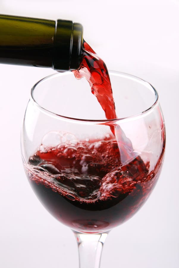 Red wine pouring into wine glass stock photos