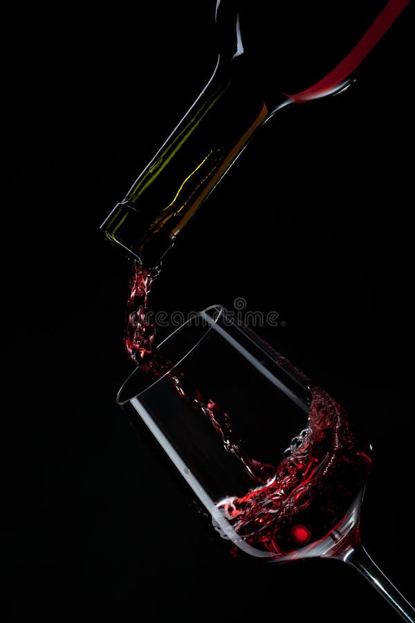 Red Wine Pouring into Wine Glass Isolated on Black Stock Photo Image