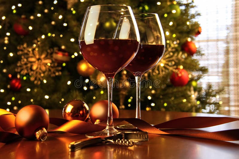 Red wine on table with Christmas tree