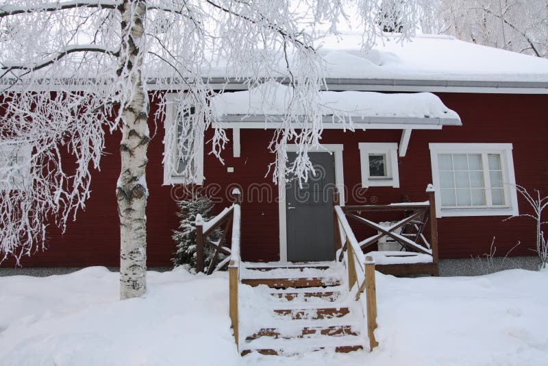 Red wooden Finnish house in winter