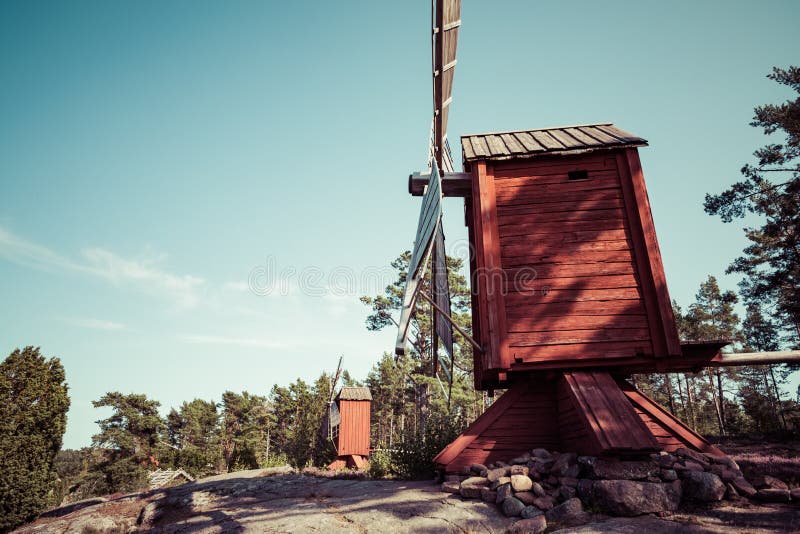 Red wooden windmill in a old vintage rural landscape at Aland islands, Finland. Jan Karlsgarden open air museum. Ethnographic park stock photos Red wooden windmill in a old vintage rural landscape at Aland islands, Finland. Jan Karlsgarden open air museum. Ethnographic park stock photos