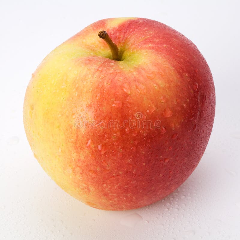 Red-yellow apple covered with water drops