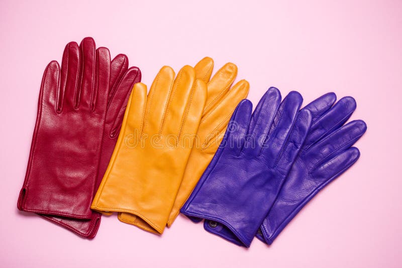Red, Yellow and Blue Gloves on a Pink Background Stock Photo Image of