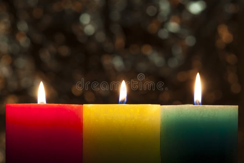 Red, yellow and green colourful candles with blurred bokeh background. Christmas and New Year copy space. stock image Red, yellow and green colourful candles with blurred bokeh background. Christmas and New Year copy space. stock image