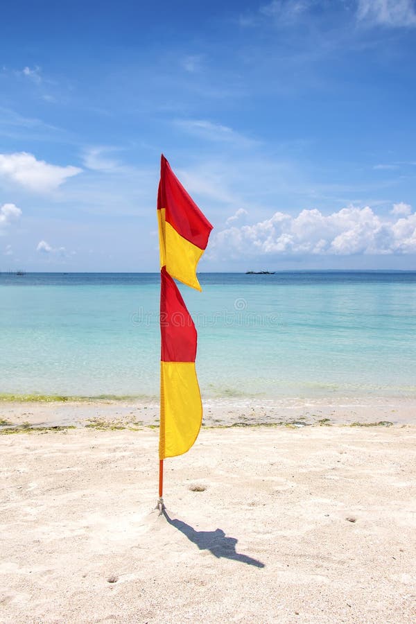 Red and Yellow Lifeguard Flags at Beach on Bantayan Island in the