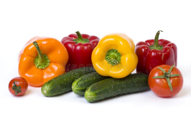 Red yellow and orange peppers with tomatoes on a white background. Cucumbers with colorful peppers in composition on a white backg