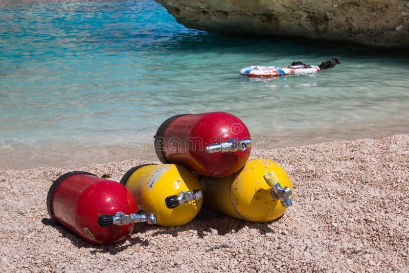 Red and Yellow Scuba Oxygen Tanks for Divers on a Beach