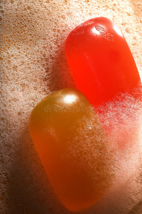 Red and yellow soap in foam royalty free stock photo