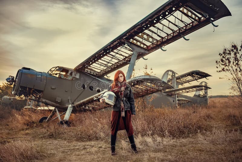 Redhead girl in black leather jacket and helmet