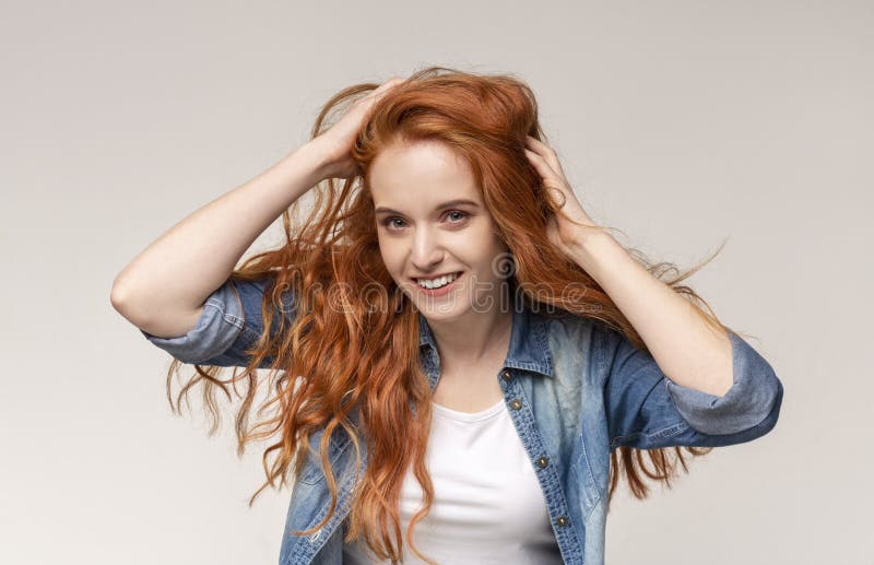 Redhead Girl Brushing Hair With Fingers Enjoying Her Natural Look