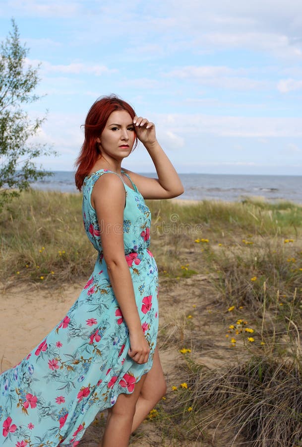 Redhead Girl in Long Dress Standing at the Seashore Stock Image - Image ...