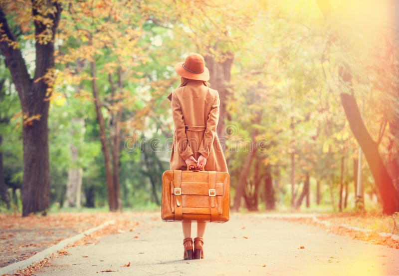 Redhead girl with suitcase