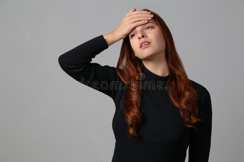 The Redhead Girl Tired And Has A Headache At Gray Background Stock 