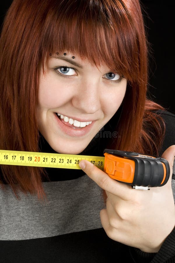 Redhead girl using measuring tape tool