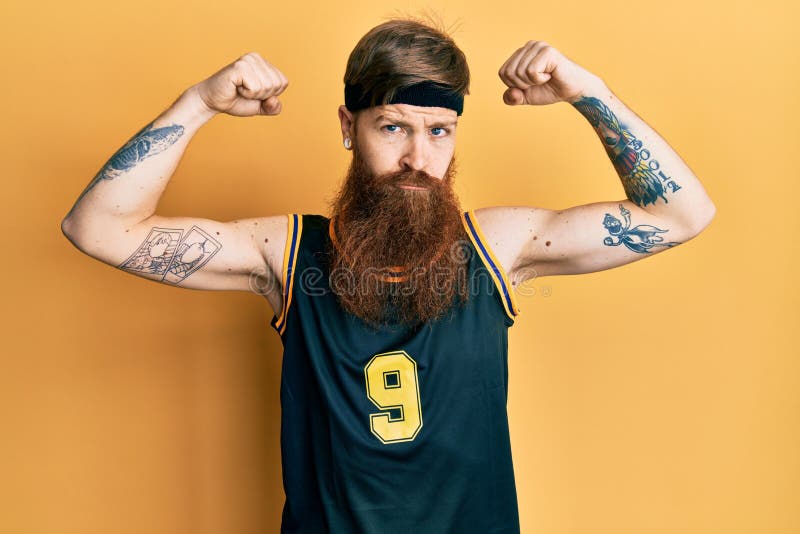 Redhead Man with Long Beard Wearing Basketball Uniform Showing Muscles