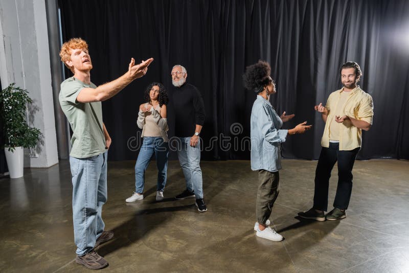 Redhead man rehearsing with outstretched hand stock image