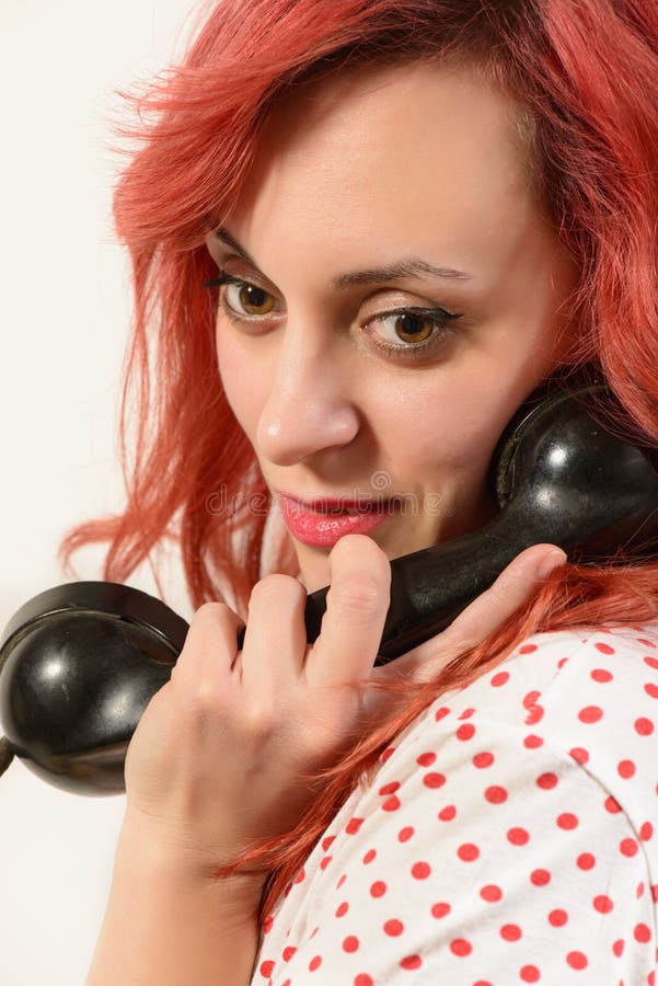 Redhead Woman With A Retro Look Speaking At A Vintage Phone Stock Image 