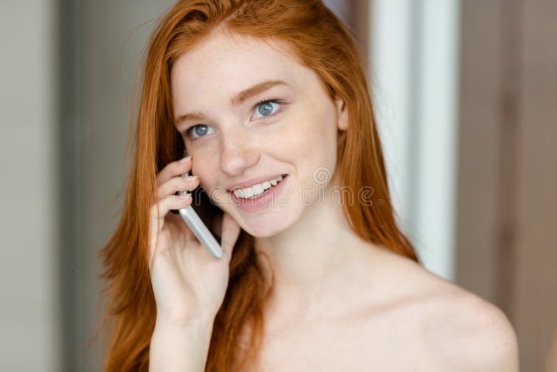 Redhead woman talking on the phone stock photo