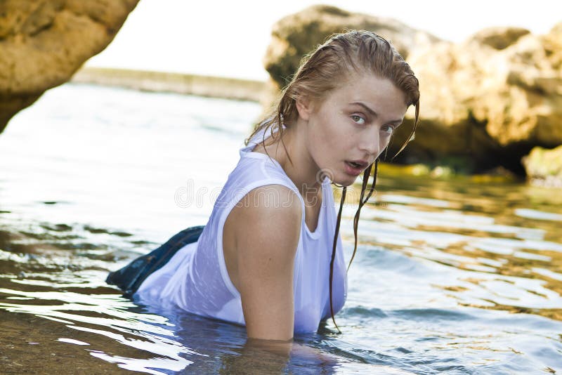 Redheaded girl in a wet white T-shirt