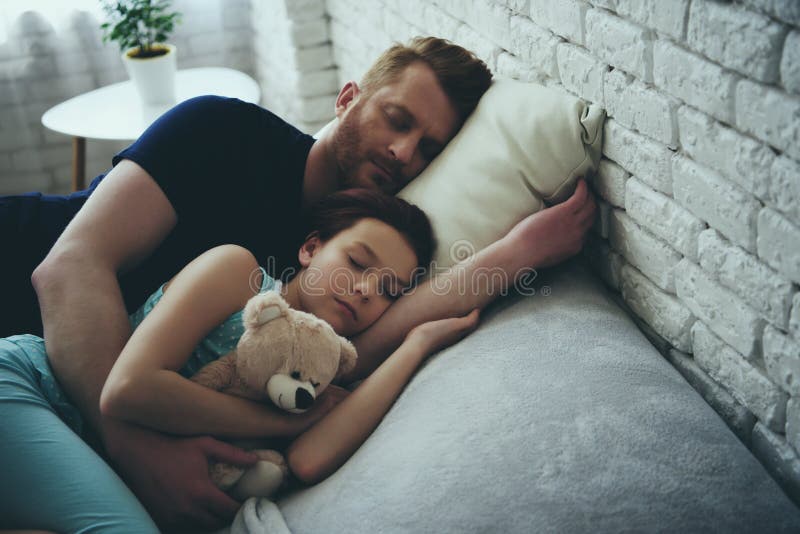 Redheaded single father and daughter are sleeping. 