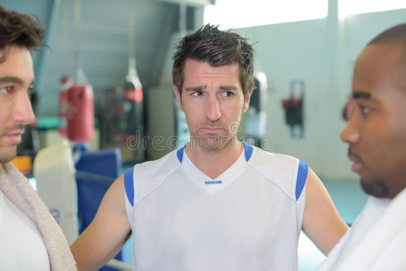 Referee in between two boxers psyching eachother out frown