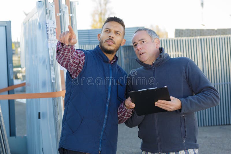 Refinery workers discussion and pointing for inspection