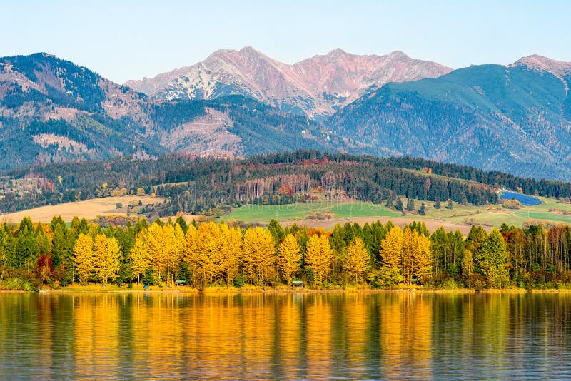 Reflection of autumn trees on lake