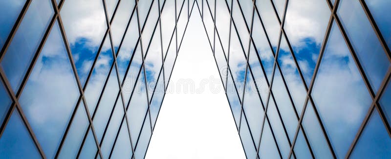 Reflection of blue sky with clouds in an office building window