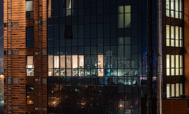 Reflection Of City Lights From The Glass Of A Part Of A Skyscraper At reflection-of-city-lights-from-the-glass-of-a-part-of-a-skyscraper-at