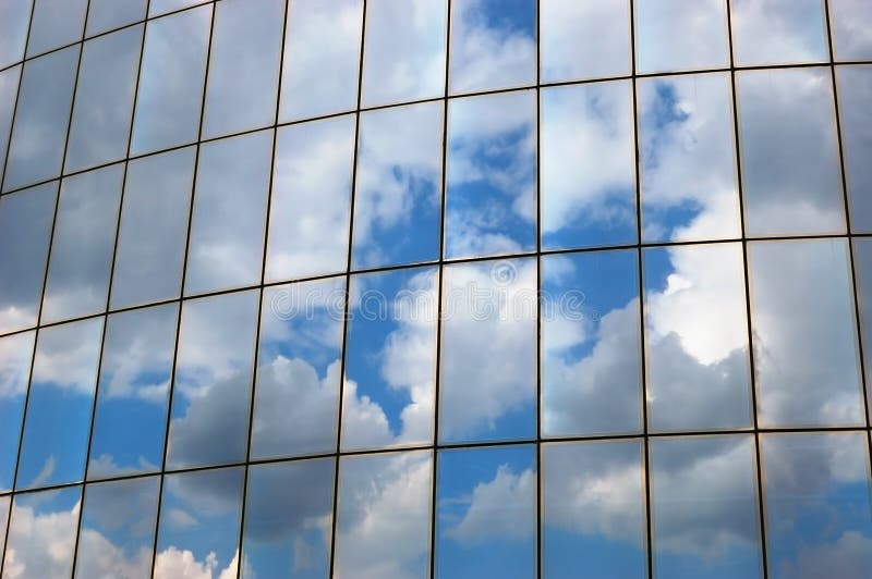 Reflection of a cloudy sky in glass wall