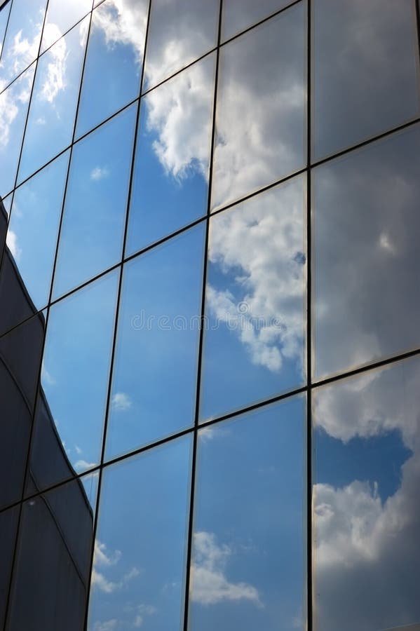 Reflection of a cloudy sky in glass wall