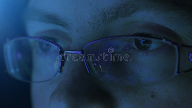 Reflection in the eye and glasses of the monitor screen when woman surfing the Internet.