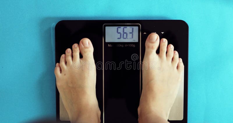 Woman standing on scales. Weight loss concept :: Stock Photography Agency  :: Pixel-Shot Studio