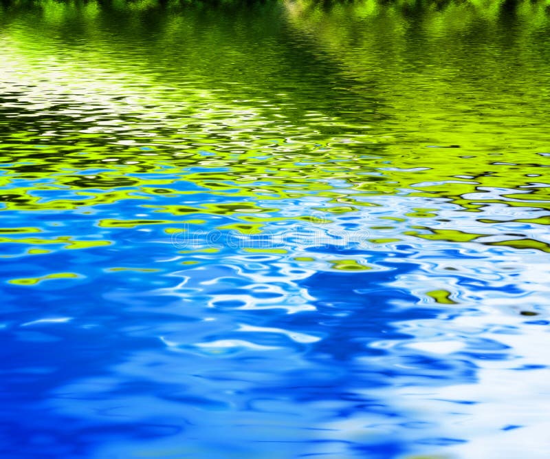 Reflection of green nature in clean water waves.