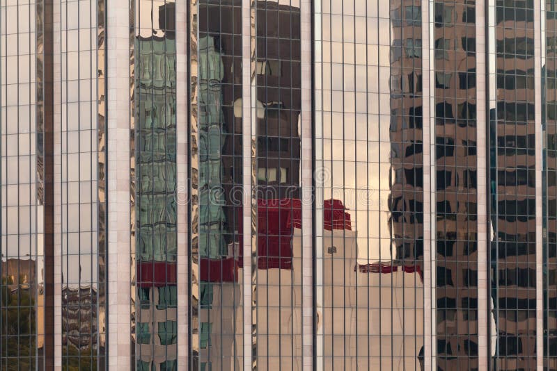 Reflections in modern glass-walled building facade