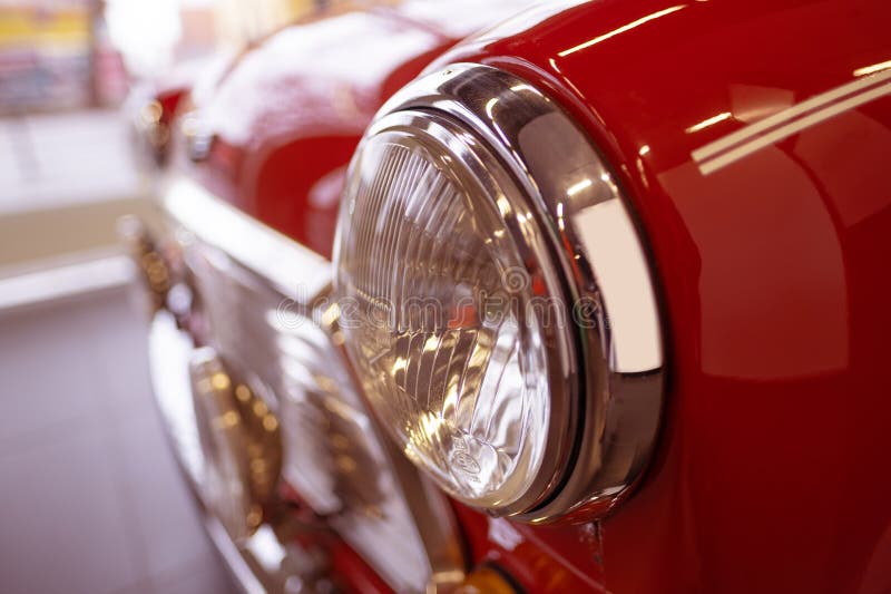 close-up headlamp vintage Red Classic Rover MINI Cooper 1,3 Oldtimer in showroom, iconic design technology, retro-style, Automotive Industry, Frankfurt, Germany - January 21, 2024. close-up headlamp vintage Red Classic Rover MINI Cooper 1,3 Oldtimer in showroom, iconic design technology, retro-style, Automotive Industry, Frankfurt, Germany - January 21, 2024