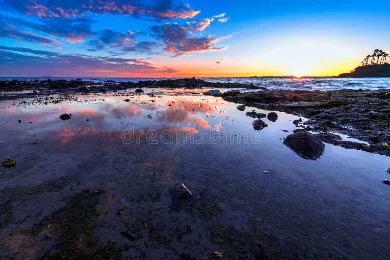 Reflecting water and sun setting in Laguna Beach, CA. Reflecting water and sun setting in Laguna Beach, CA