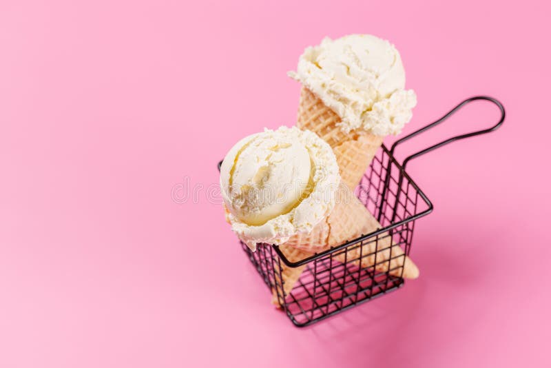 A refreshing ice cream cones set against a vibrant pink background stock photos