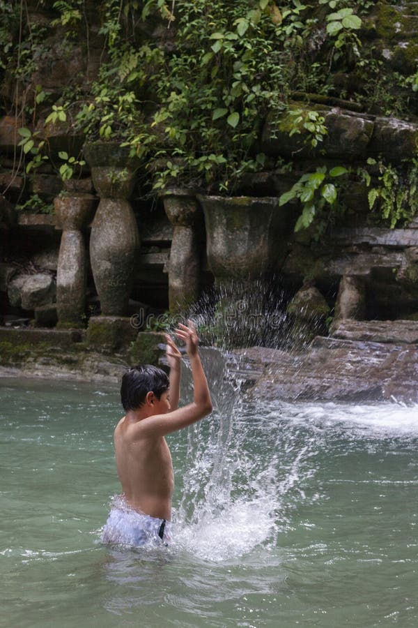 Refreshing image of a boy playing with water in a waterfall near Aquismón, Mexico stock image Refreshing image of a boy playing with water in a waterfall near Aquismón, Mexico stock image