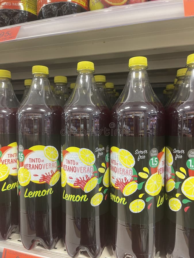 Refreshing lemon beverage bottles on supermarket shelf for summer promotion stock photo