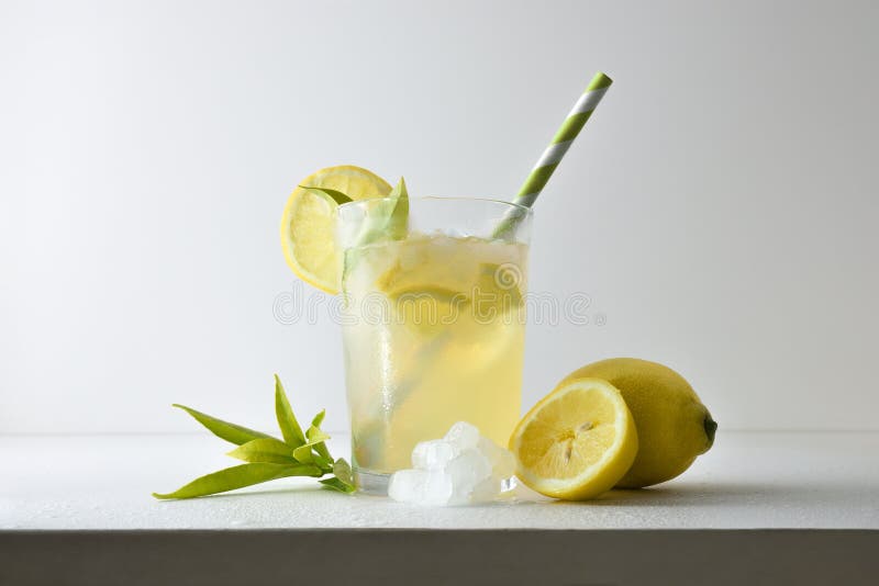 Refreshing lemon drink with ice on a white isolated background royalty free stock photo