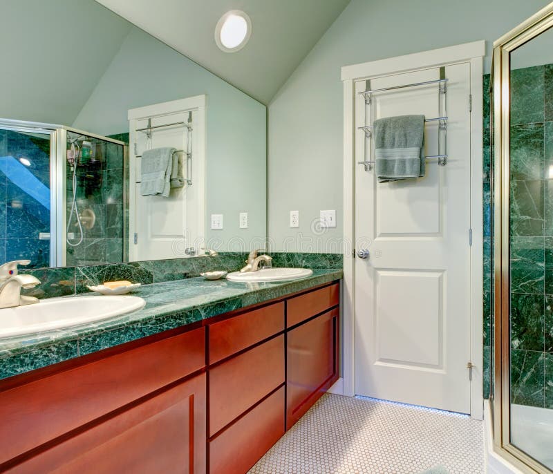 Refreshing Light Green Bathroom with Bright Brown Cabinets Stock Image ...