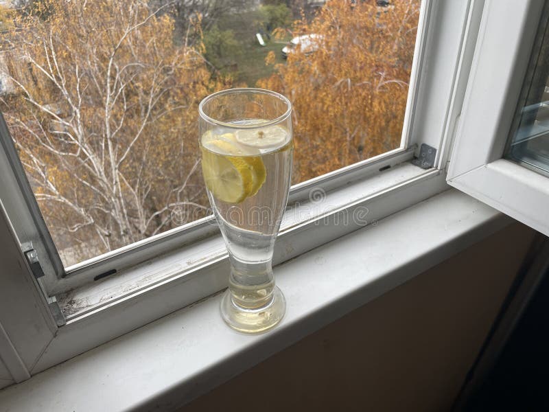 Refreshing water with lemon wedges drink stock photo