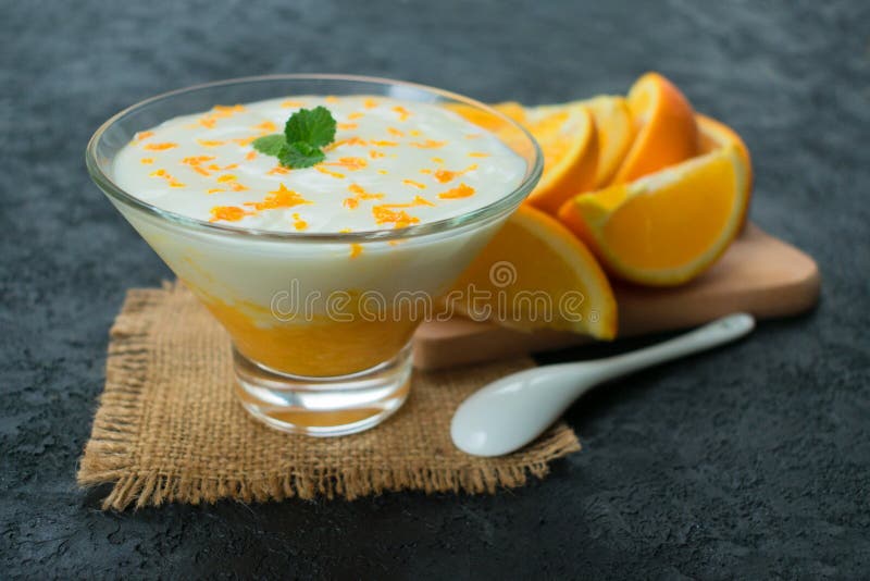 Refreshing Yogurt Dessert with Orange Smoothie on a Black Background