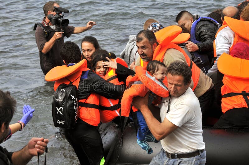 Refugiados que chegam em Grécia no barco deslustrado de Turquia fotos de stock Refugiados que chegam em Grécia no barco deslustrado de Turquia fotos de stock