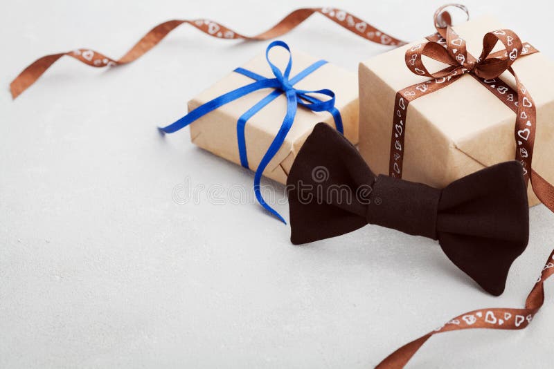 Gift or present box with ribbon and bowtie on desk for Happy Fathers Day, copy space for your text or design. Gift or present box with ribbon and bowtie on desk for Happy Fathers Day, copy space for your text or design
