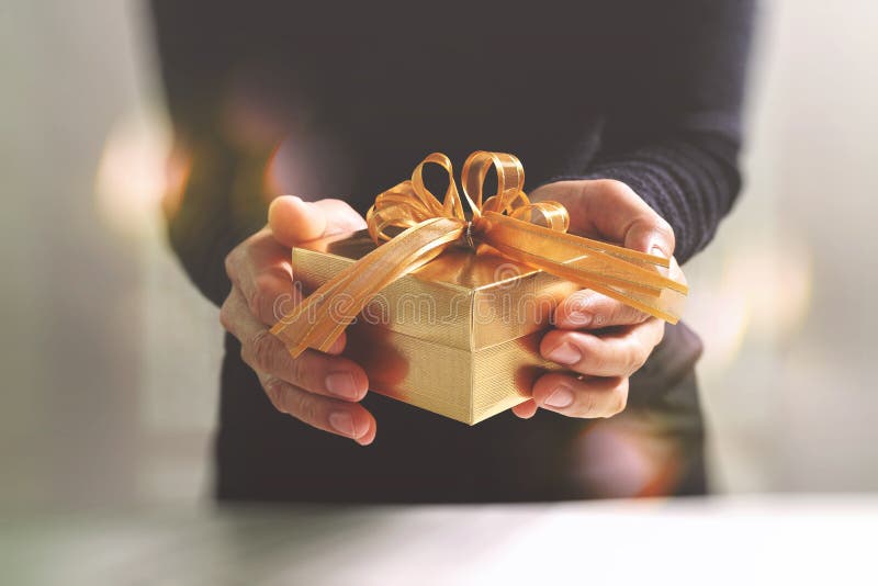 regalo que da, mano del hombre que sostiene una caja de regalo en un gesto del donante B