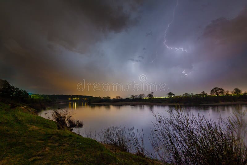 Regen en bliksem boven de rivier stock afbeelding