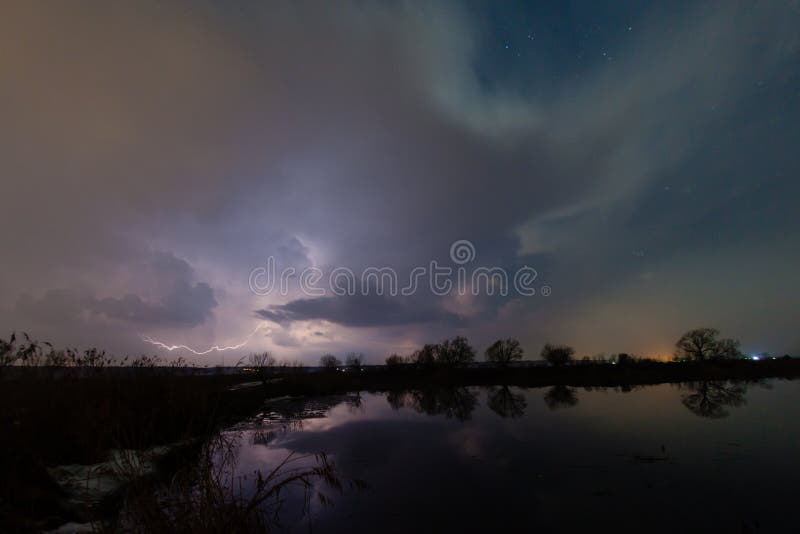 Regen en bliksem boven de rivier stock afbeelding