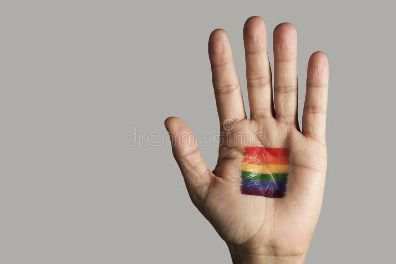 Regenboogvlag in de palm van de hand stock afbeelding Regenboogvlag in de palm van de hand stock afbeelding